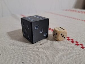 Iso 3 cm 3D‑tulostettu noppa puunopan vieressä